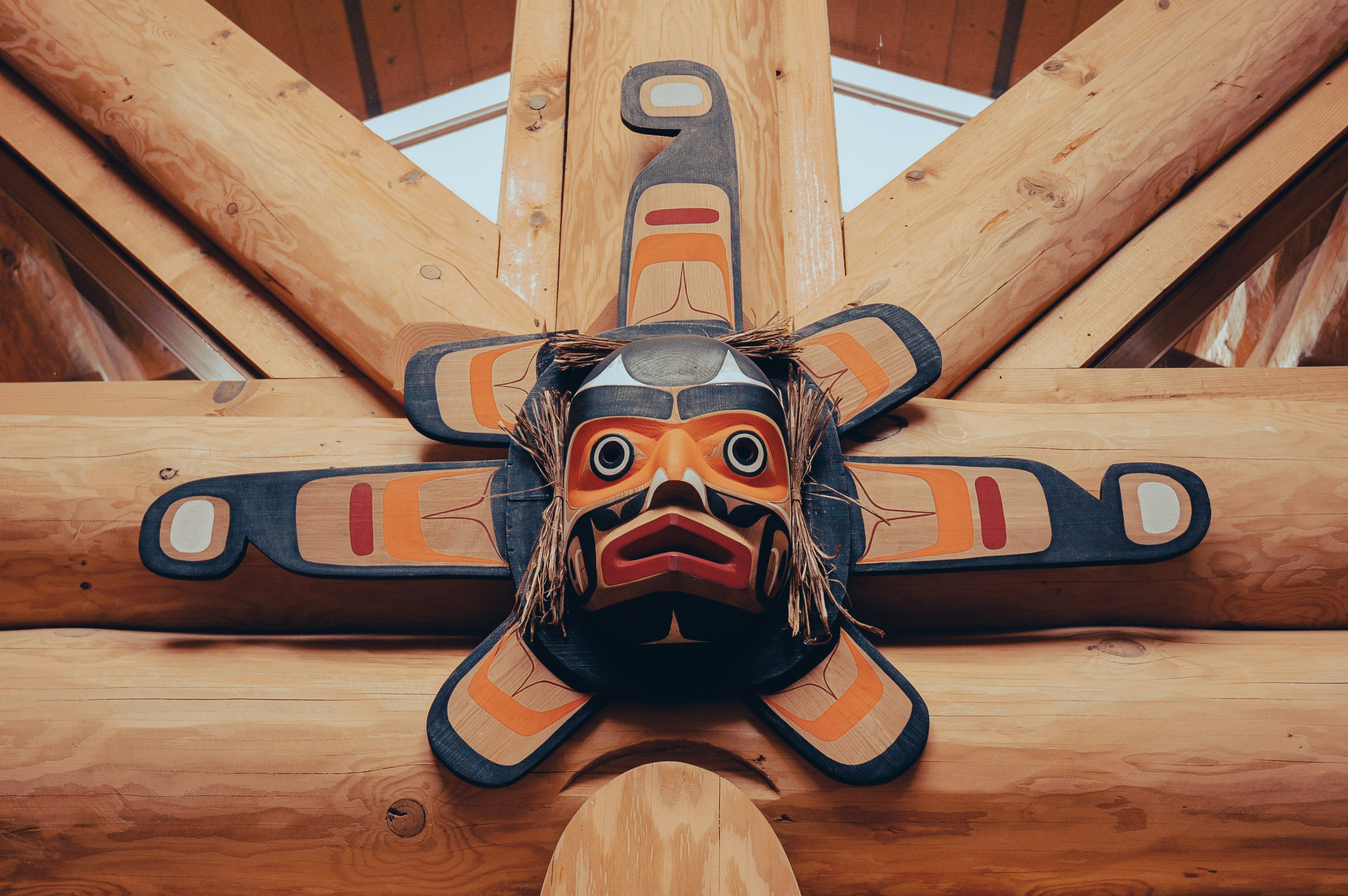 Carved art inside a cedar longhouse